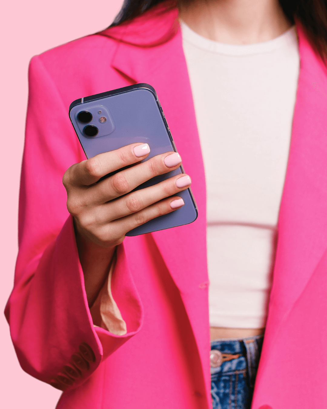 Woman in pink blaze holding a cell phone