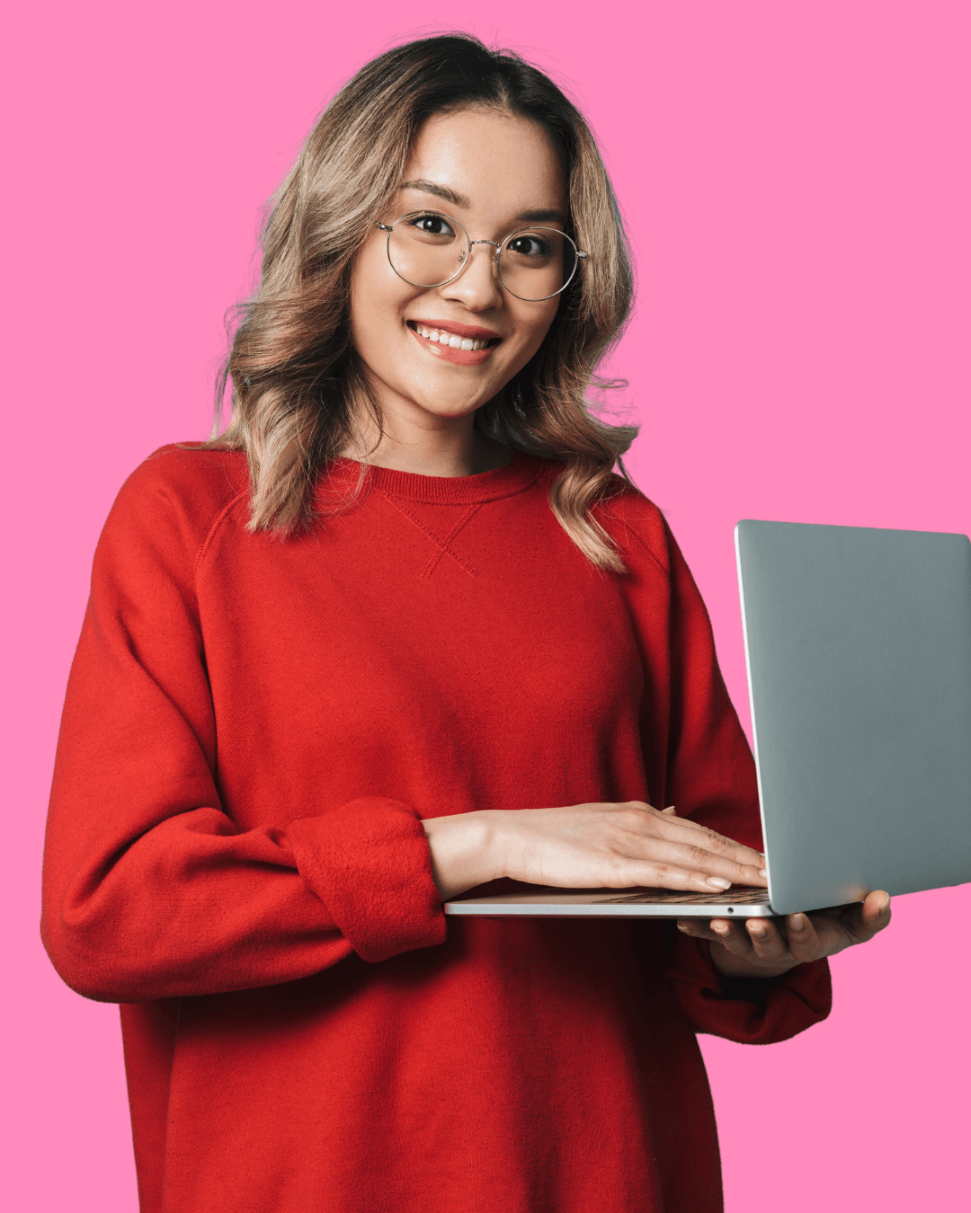 Woman in red shirt and glasses holding a laptop.